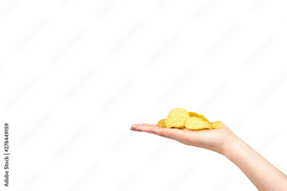 Fototapeta premium Hand with golden color potato chips, crunchy and wavy.