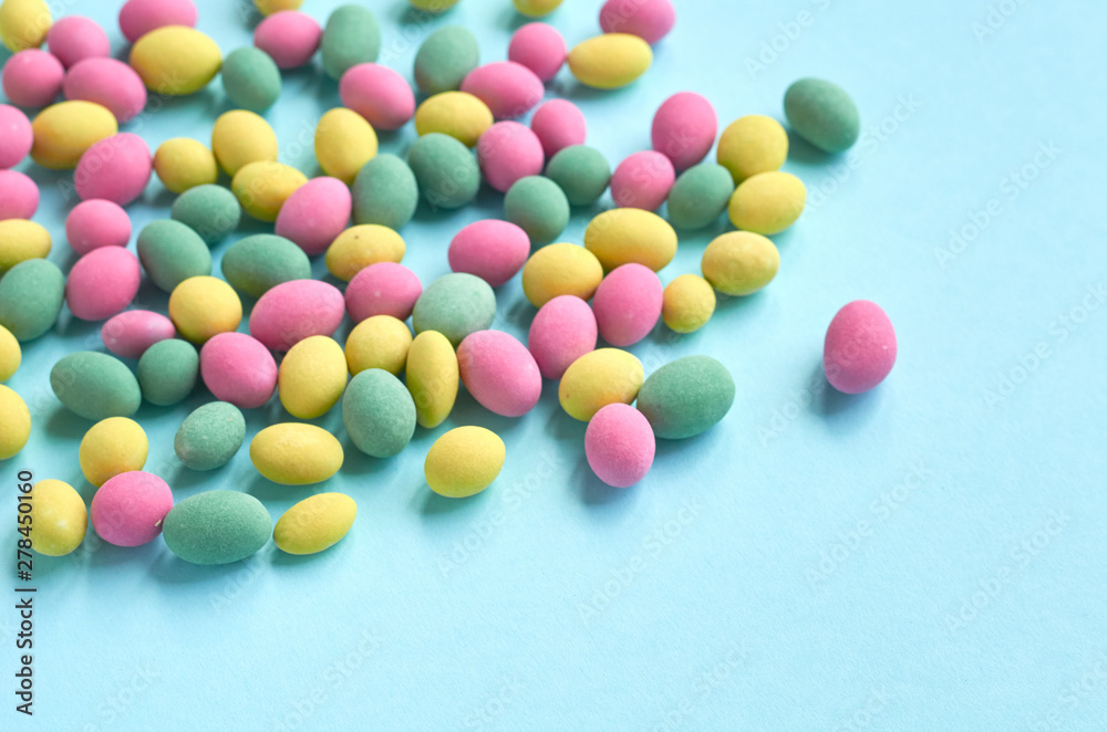 Colored sweets, peanut covered with glaze on blue background composition. Colored sweets, peanut covered with glaze on blue background composition.
