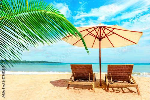 Chairs on the tropical beach near sea, Thailand. Holidays Background.