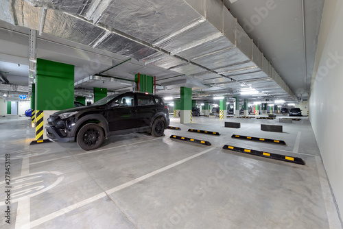 Modern underground parking garage with cars