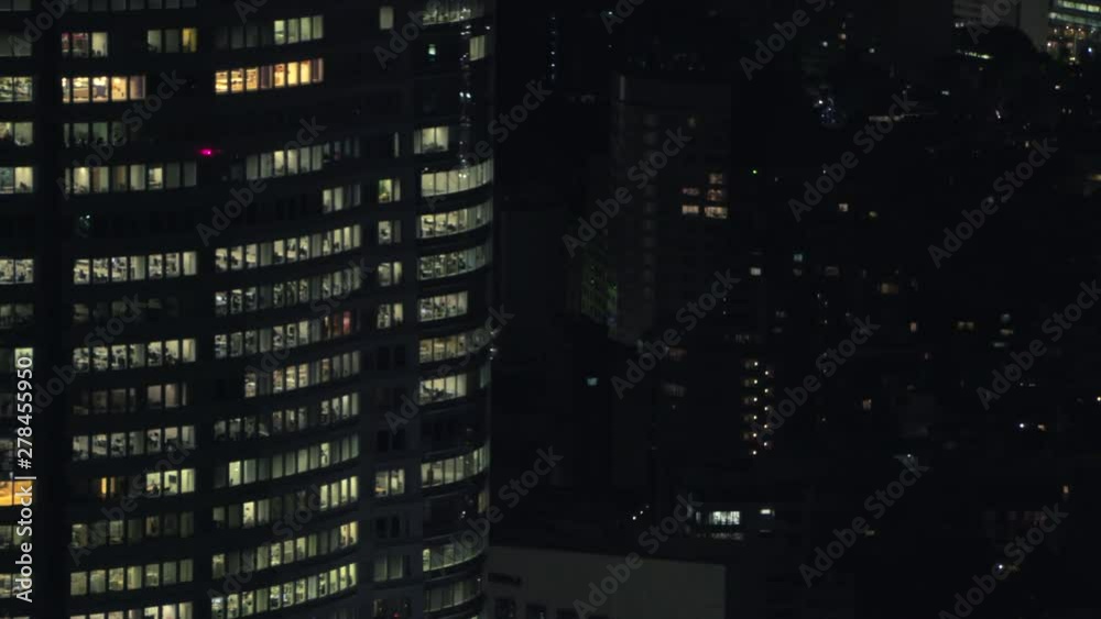 Windows of Offices in Business Building in Tokyo Japan at Night. People Working Extra Hours Windows of Offices in Business Building in Tokyo Japan at Night. People Working Extra Hours