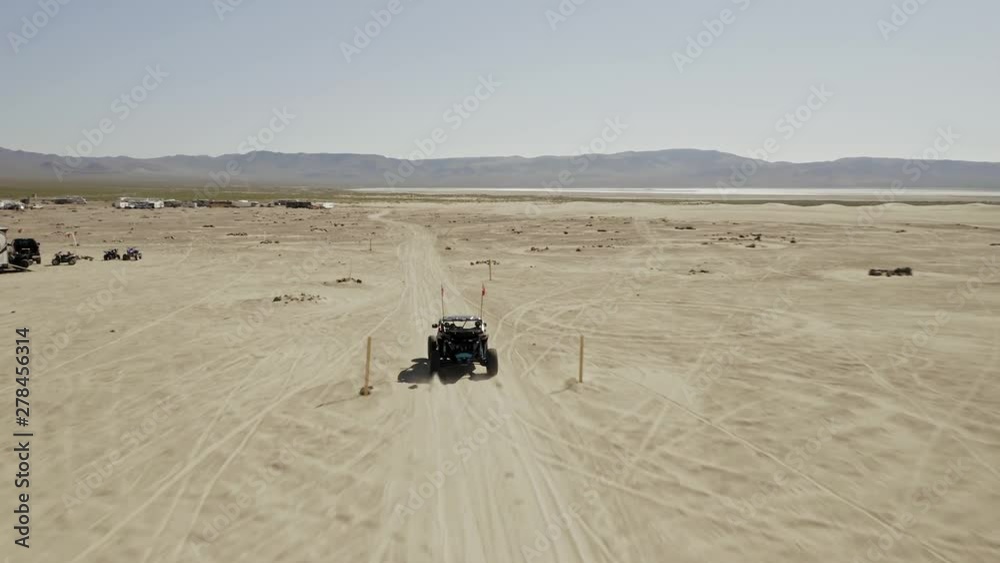 Aerial: Dune buggy ATV racing on the sand dunes at White Sands National Monument in Nevada, USA Aerial: Dune buggy ATV racing on the sand dunes at White Sands National Monument in Nevada, USA