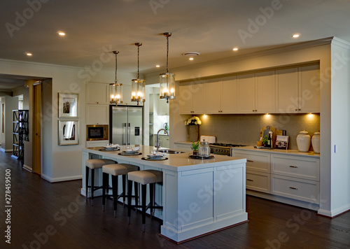 Large luxurious kitchen with ambient lighting and wooden floor photo