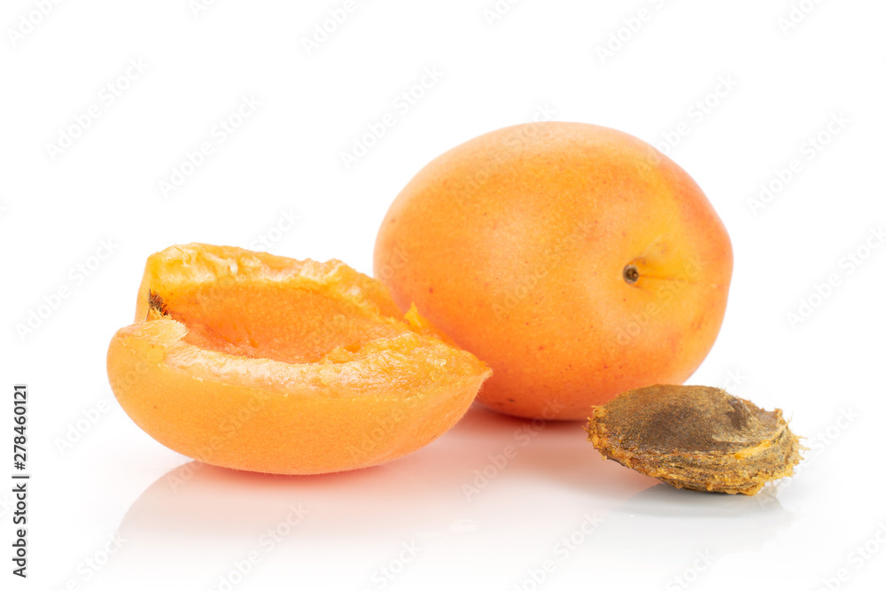 Group of one whole one half of ripe fresh deep orange apricot with a stone isolated on white background