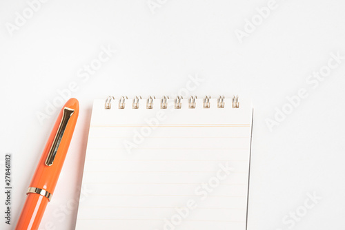 Orange Fountain Pen with Spiral-Bound Notebook photo