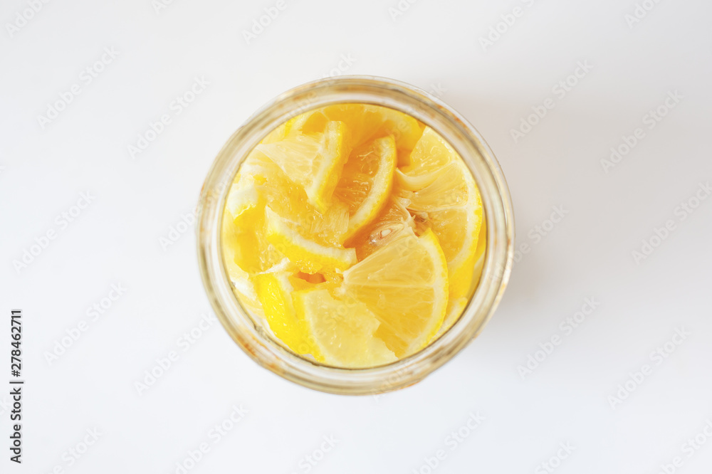 fresh lemon in sugar syrup in a jar top view fresh lemon in sugar syrup in a jar top view