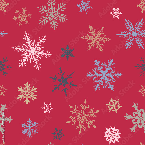 Christmas seamless pattern of complex big and small multicolored snowflakes on pink background