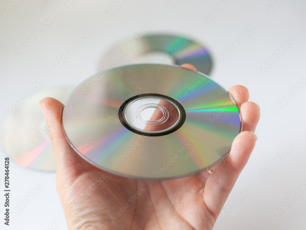 cd compact disc in the hand on white background cd compact disc in the hand on white background