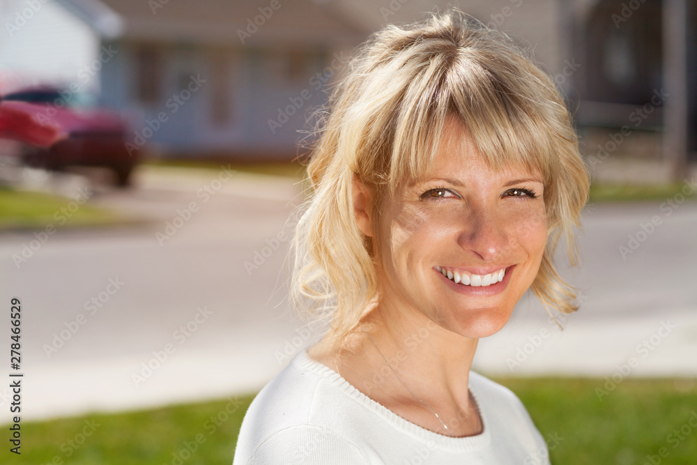 Portrait Of A Mature Woman Smiling At the Camera Outside in front of her house Portrait Of A Mature Woman Smiling At the Camera Outside in front of her house