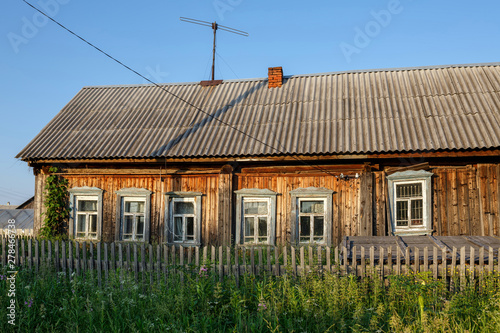 Village street in summer. Old wooden house. Ancient village of Visim, Sverdlovsk region, Urals, Russia. photo