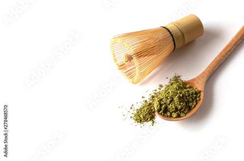 Matcha powder in a wooden spoon with  with a bamboo chasen (whisk). Japanese Culture. Tea Ceremony Concept photo