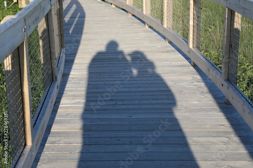 man and waman walking on the bridge