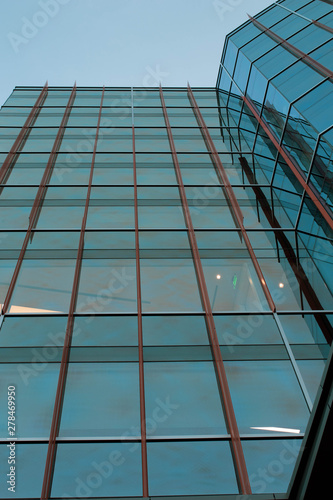 modern office building with reflection in windows of building