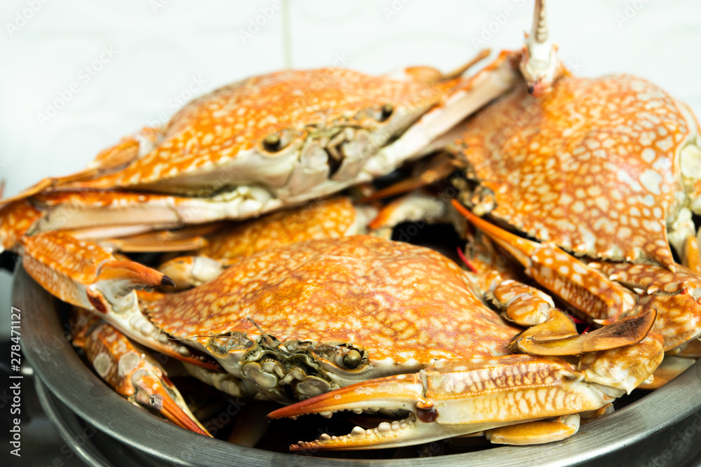 Closeup mouth-watering steamed crabs in steamer container, delicious Thai style seafood cooking background. Closeup mouth-watering steamed crabs in steamer container, delicious Thai style seafood cooking background.