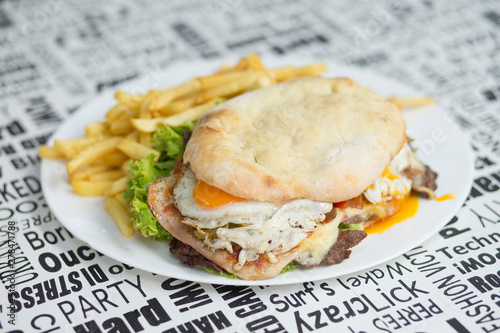 Plato de chivito al pan con papas fritas photo