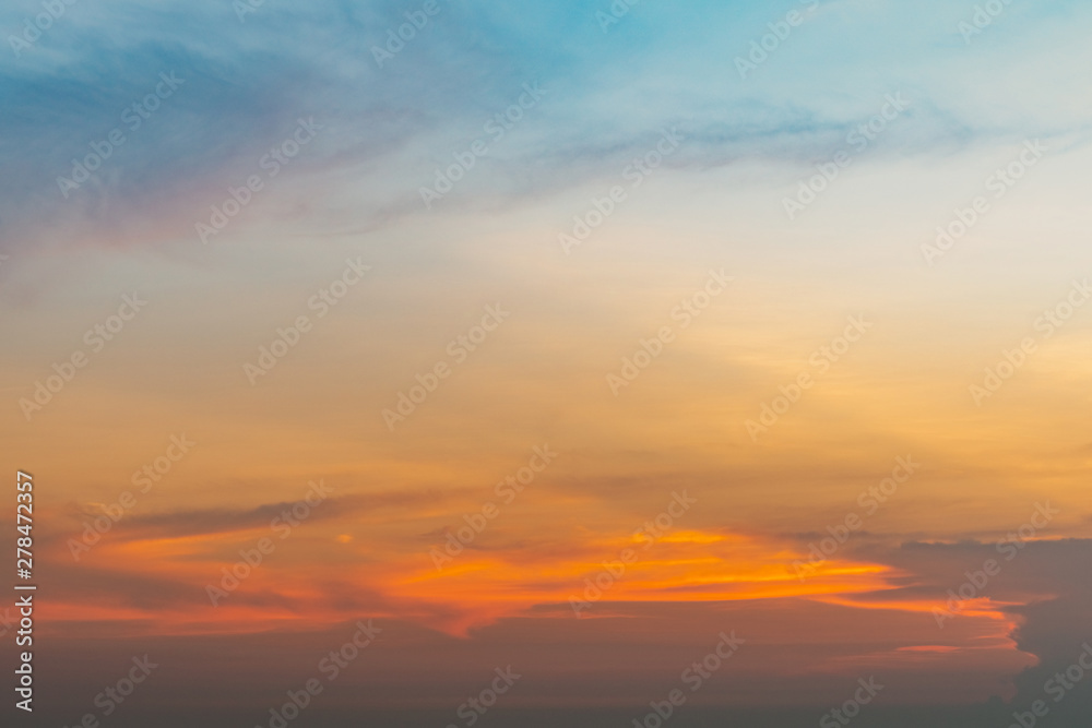 Beautiful sunset sky. Orange, blue, and yellow sky. Colorful sunset. Art picture of sky at sunset. Sunset and clouds for inspiration background. Nature background. Peaceful and tranquil concept.