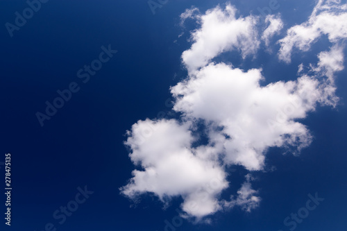 Beautiful deep blue sky with white puffy clouds on a sunny day.White Clouds on blue sky concept.
