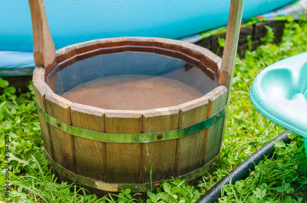 wooden barrel with water in the summer garden wooden barrel with water in the summer garden