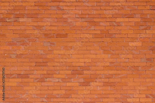 Traditional vintage reddish orange brick wall texture background with weathered and worn bricks