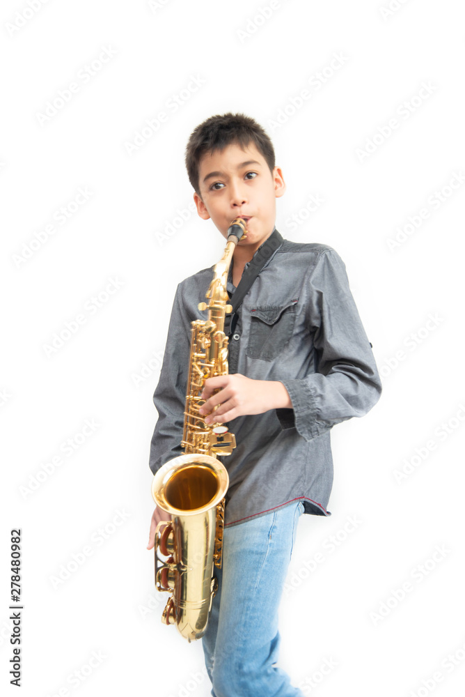 Fototapeta premium Little asian musician boy playing saxophone instrument