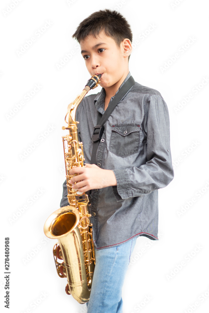 Fototapeta premium Little asian musician boy playing saxophone instrument
