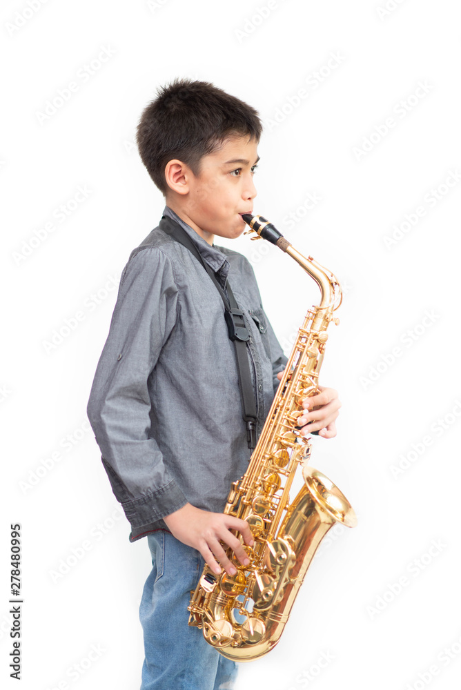 Fototapeta premium Little asian musician boy playing saxophone instrument