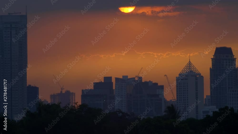 Time Lapse Golden Sunset Behind Clouds, City Skyscrapers Skyline In Silhouette Time Lapse Golden Sunset Behind Clouds, City Skyscrapers Skyline In Silhouette