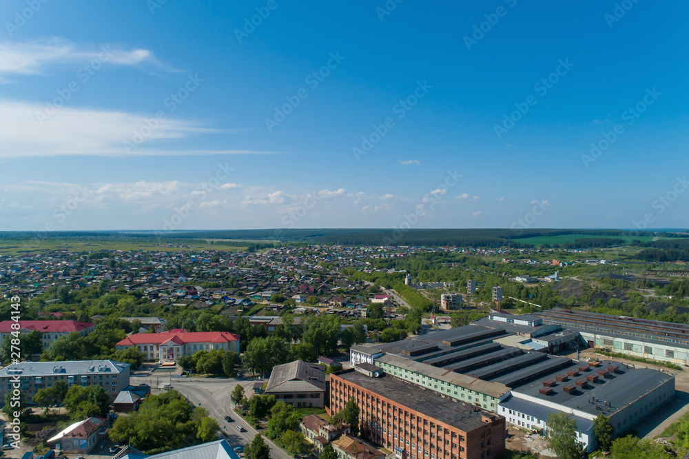 Rezh city and factory. Russia, Sverdlovsk region. Summer, sunny. Aerial