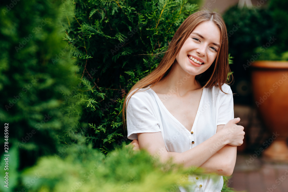 Portrait of cute red-hair girl higging herself and wide smiling posing outdoor.- Image Portrait of cute red-hair girl higging herself and wide smiling posing outdoor.- Image