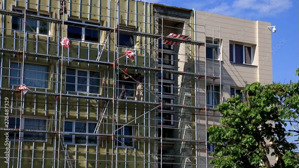 Workers On A Metal Scaffolding. Workers On A Metal Scaffolding.