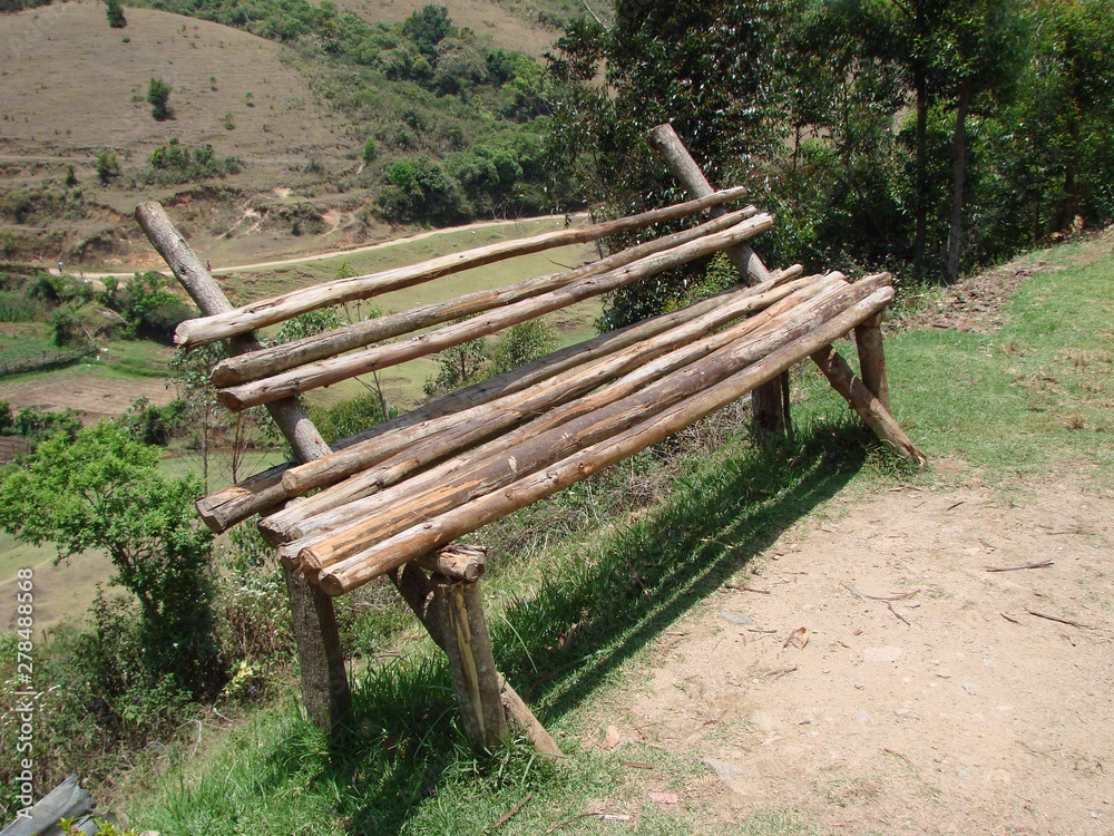 wooden bench near the vegetable fields, left side wooden bench near the vegetable fields, left side