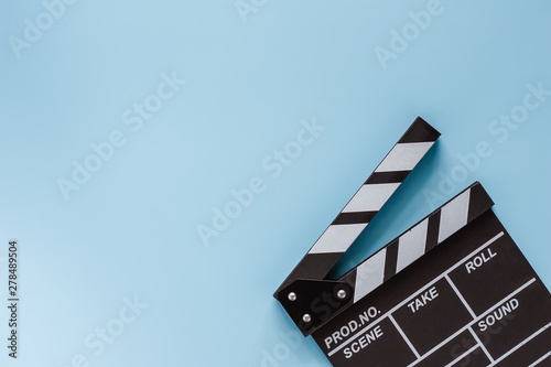 Movie clapper board on blue background for filming equipment photo