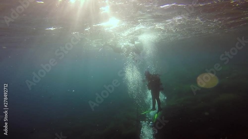 Wallpaper Mural Scuba divers descending in the open ocean with flares in slow motion. Torontodigital.ca