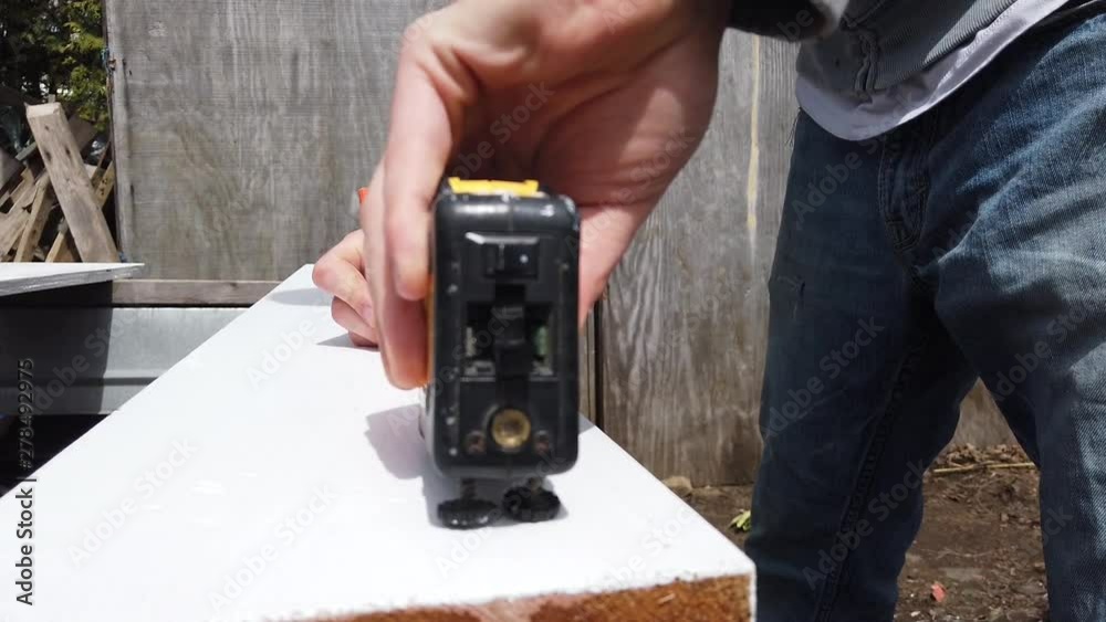 Using a tape measure on a piece of wood