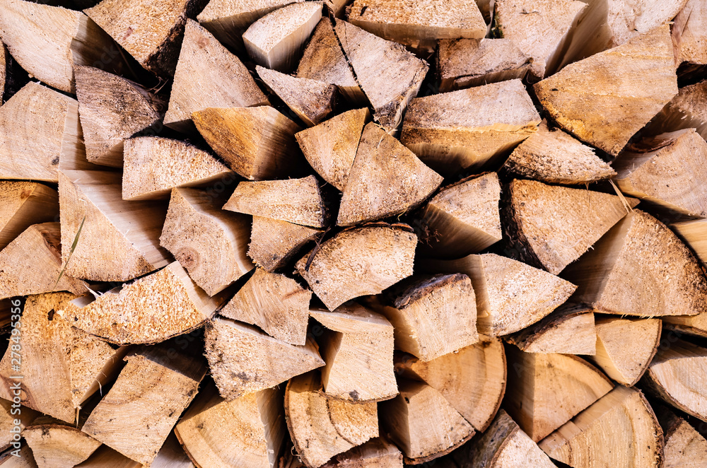 Background image - harvested firewood. The concept of rural life, summer harvesting for the winter, retro, wood, natural materials. Place for text, minimalism. Background image - harvested firewood. The concept of rural life, summer harvesting for the winter, retro, wood, natural materials. Place for text, minimalism.