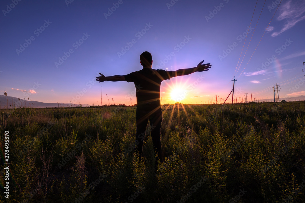 man open hand at the sunset
