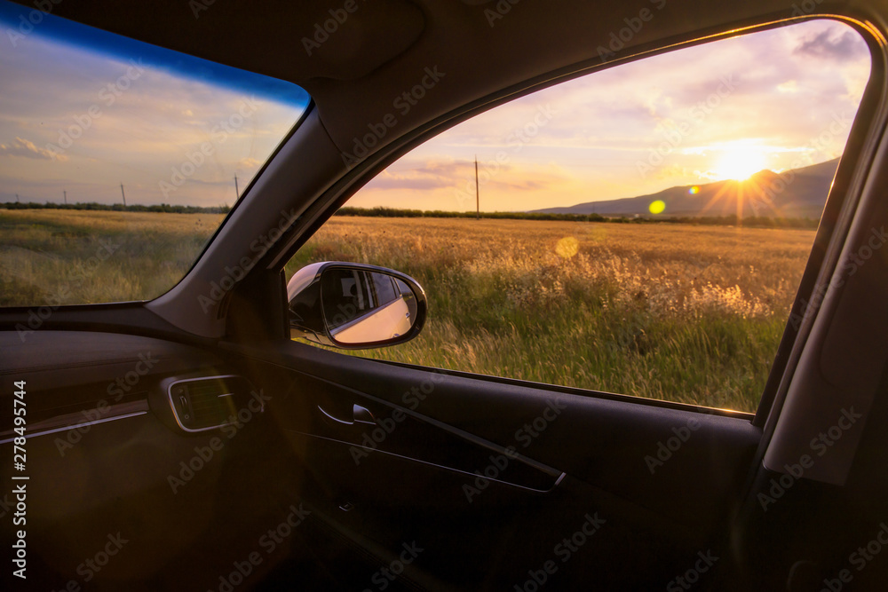 car window with sunset