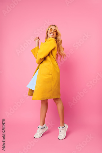 Young Girl Posing in Coat, Having Fun on Pink Background © Prostock-studio