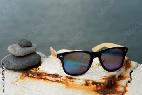 Sunglasses on the background of the sea. Travel concept