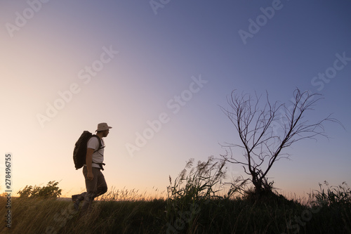 backpacker traveler walking at sunrise