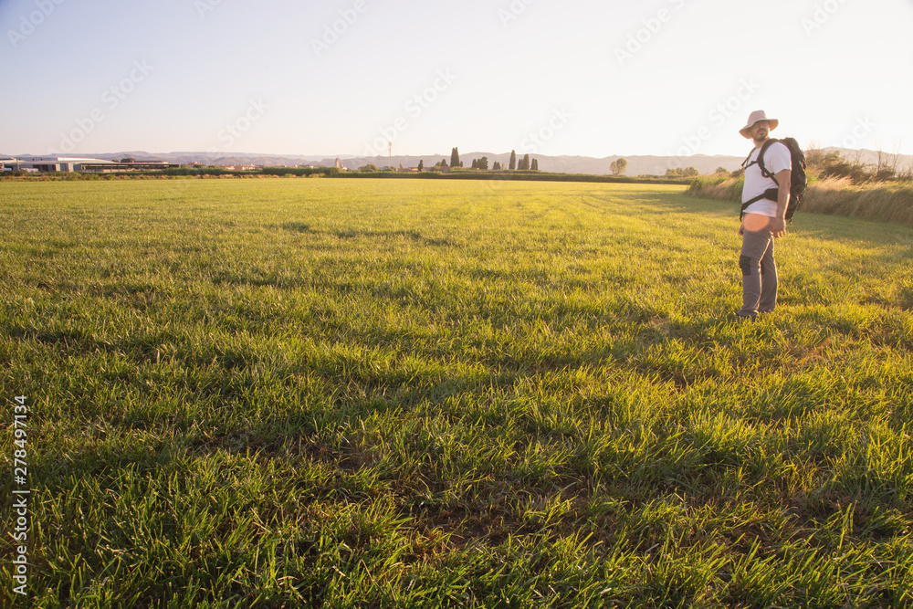 backpacker traveler walking at sunrise backpacker traveler walking at sunrise