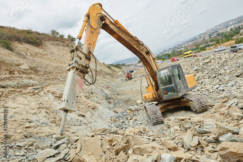 hydraulic breaker hammer excavator at demolition work