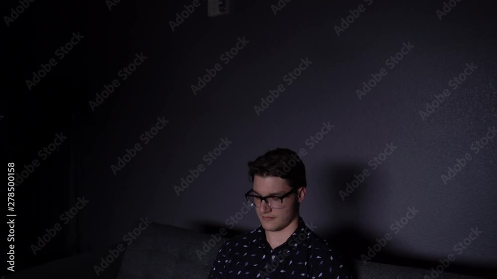 Caucasian College Student on Phone in Apartment Living Room Caucasian College Student on Phone in Apartment Living Room