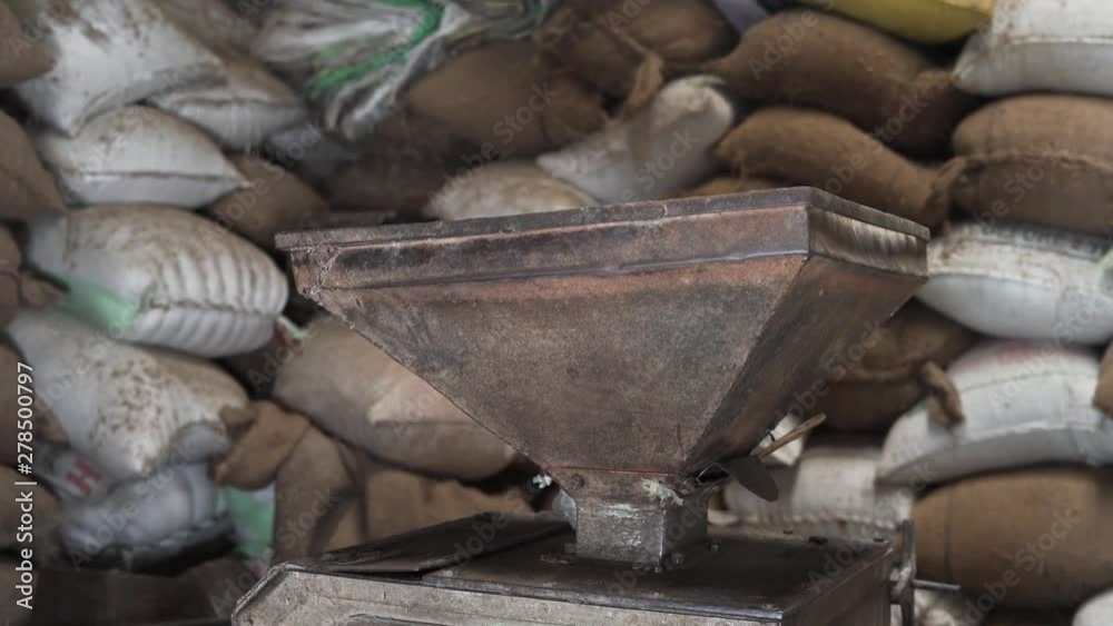 Old mill machine with background of rice bags Old mill machine with background of rice bags