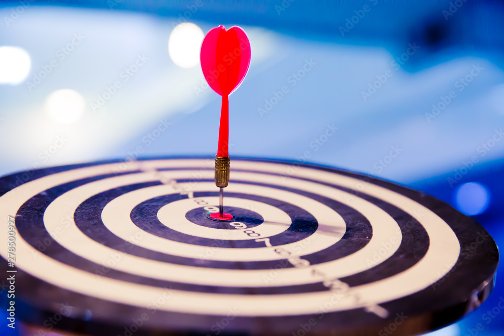Red dart arrow hitting in the target center of dartboard on bullseye for Business focus concept. Red dart arrow hitting in the target center of dartboard on bullseye for Business focus concept.