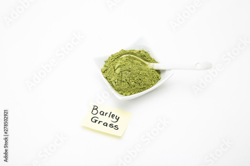 Healthy organic barley grass green powder isolated on white background. Barley grass powder for smoothies as health supplement for added vitamins and minerals to your diet. Young barley for cancer