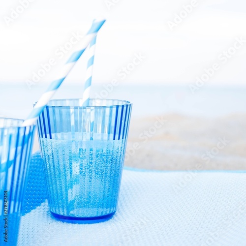 water in glass on the beach