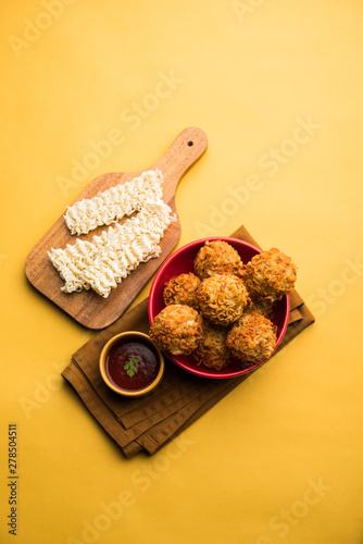 Crispy Noodles/maggie Pakora or pakoda is a popular indochinese street food served with ketchup photo