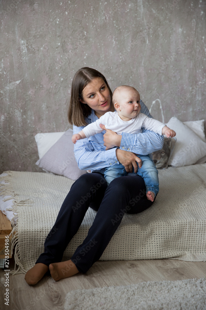 Obraz premium Caucasian Mother and Daughter Sitting on Bed