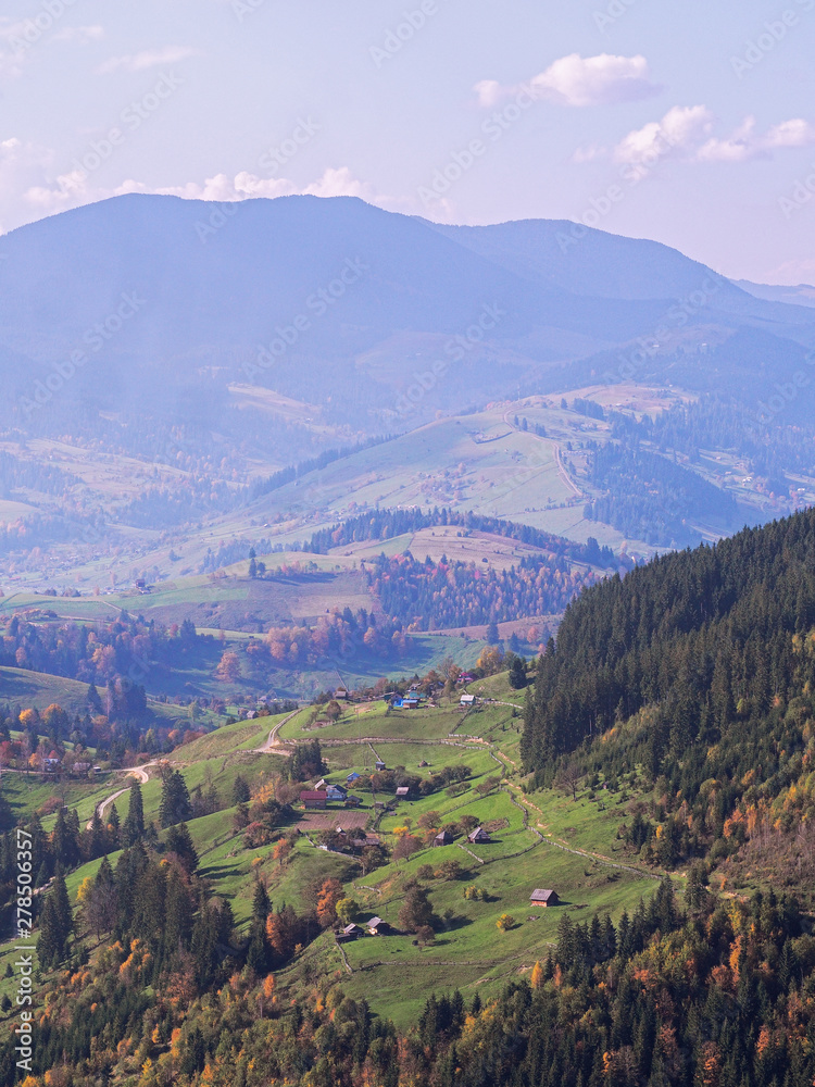 Fototapeta premium Carpatian village at mountains at the sunny day